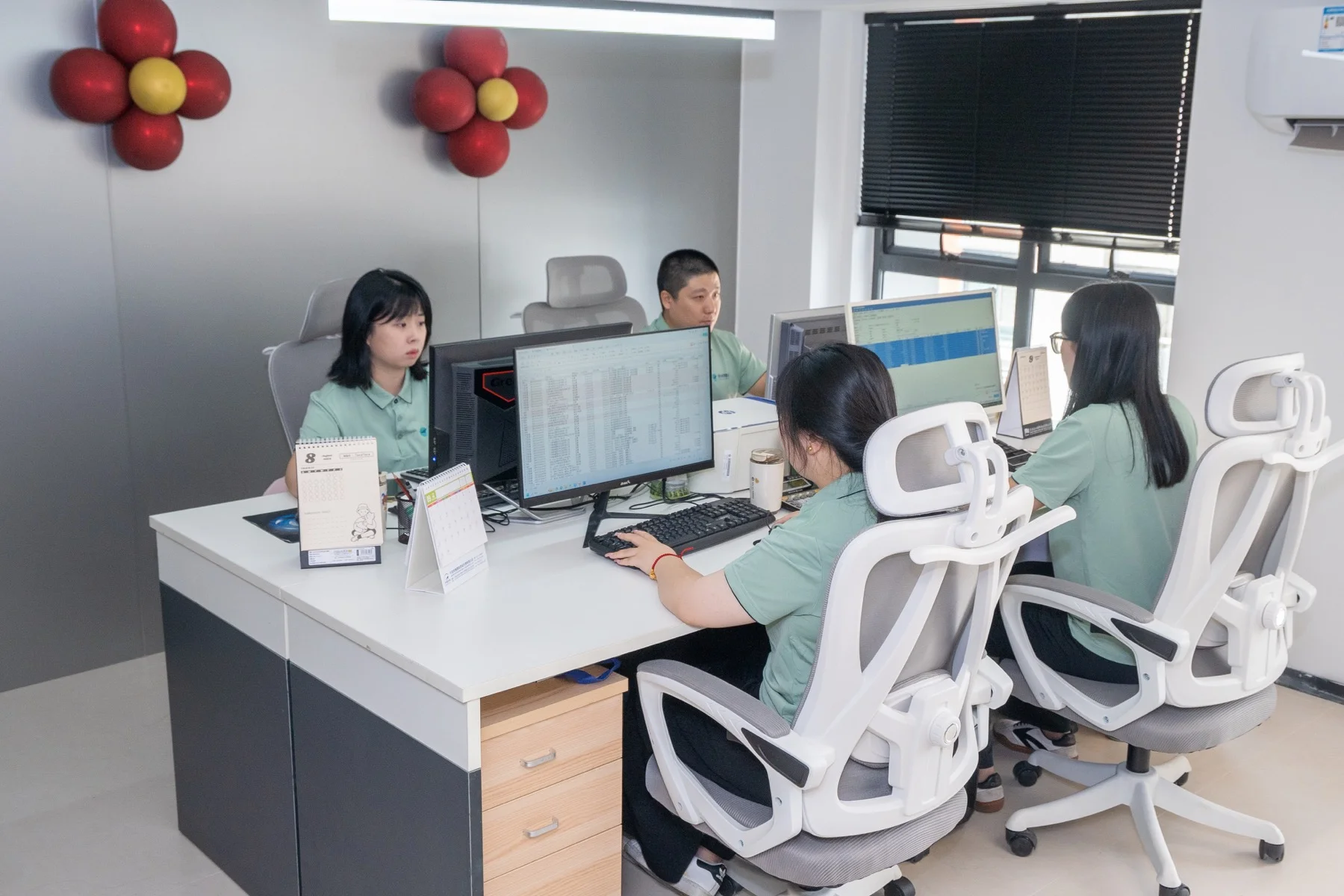 Yanchao colleagues at their office workstations